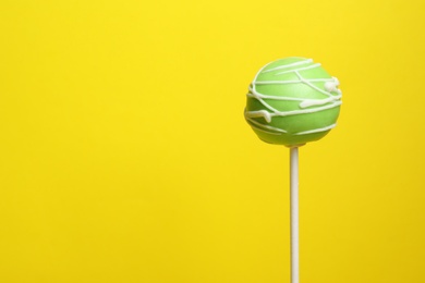 Bright delicious cake pop on color background. Space for text