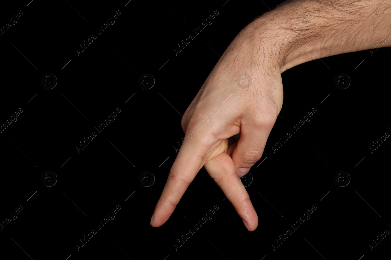 Photo of Man imitating walk with hand on black background, closeup. Finger gesture