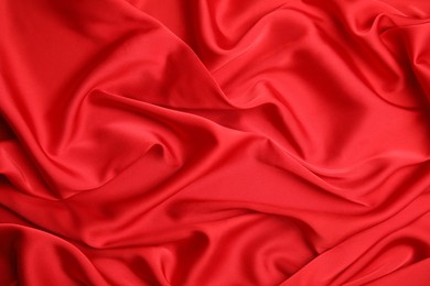 Photo of Texture of delicate red silk as background, top view