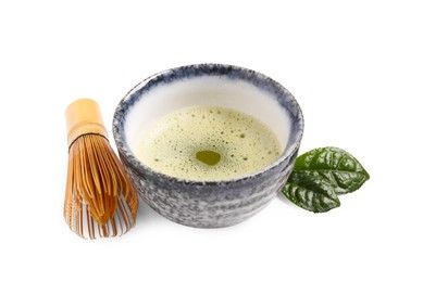 Photo of Cup of matcha tea and bamboo whisk isolated on white