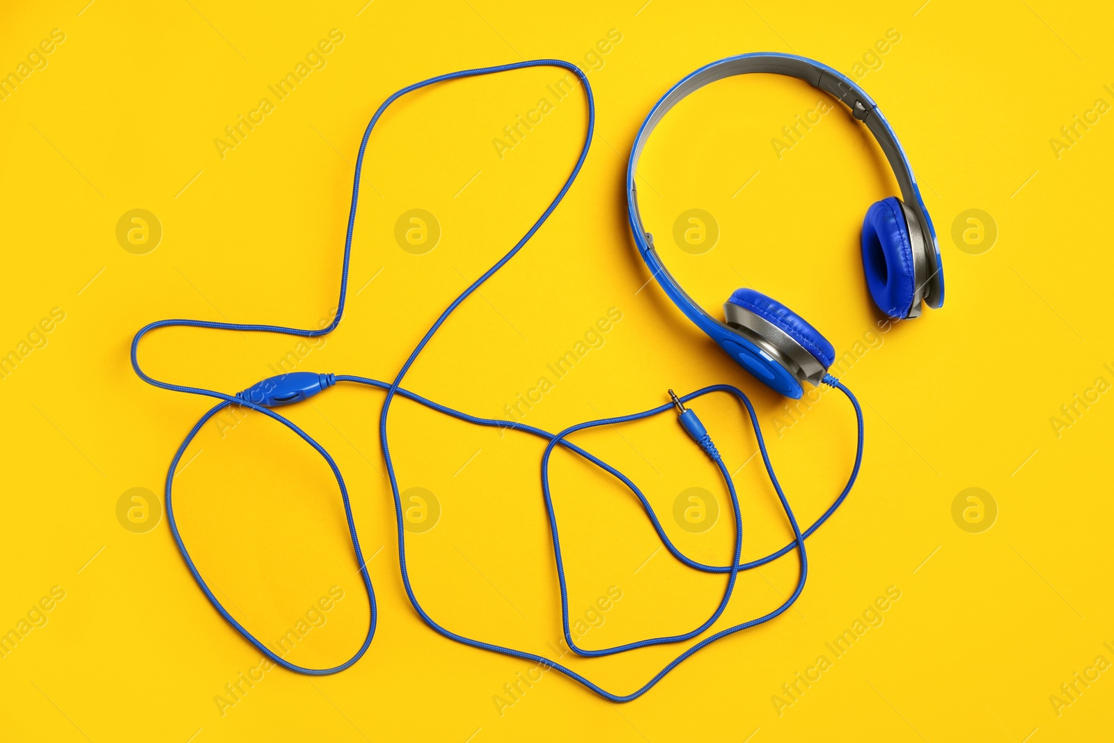 Photo of Stylish headphones on color background, top view