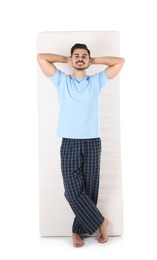 Young man with comfortable mattress isolated on white