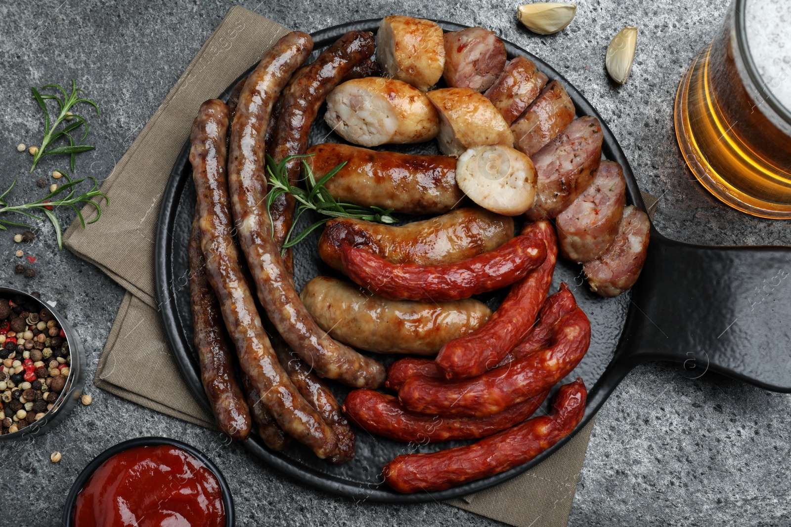 Photo of Set of different tasty snacks and beer on dark grey table, flat lay