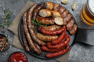 Photo of Set of different tasty snacks and beer on dark grey table, flat lay