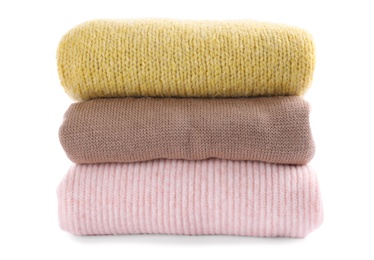 Stack of warm sweaters isolated on white