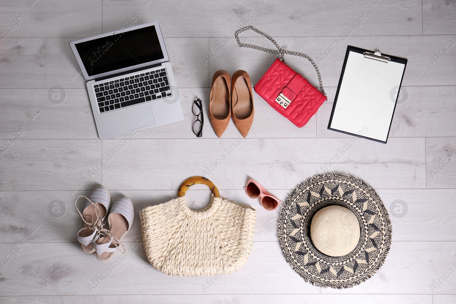 Photo of Flat lay composition of business items with vacation accessories on white wooden background. Life and work balance concept