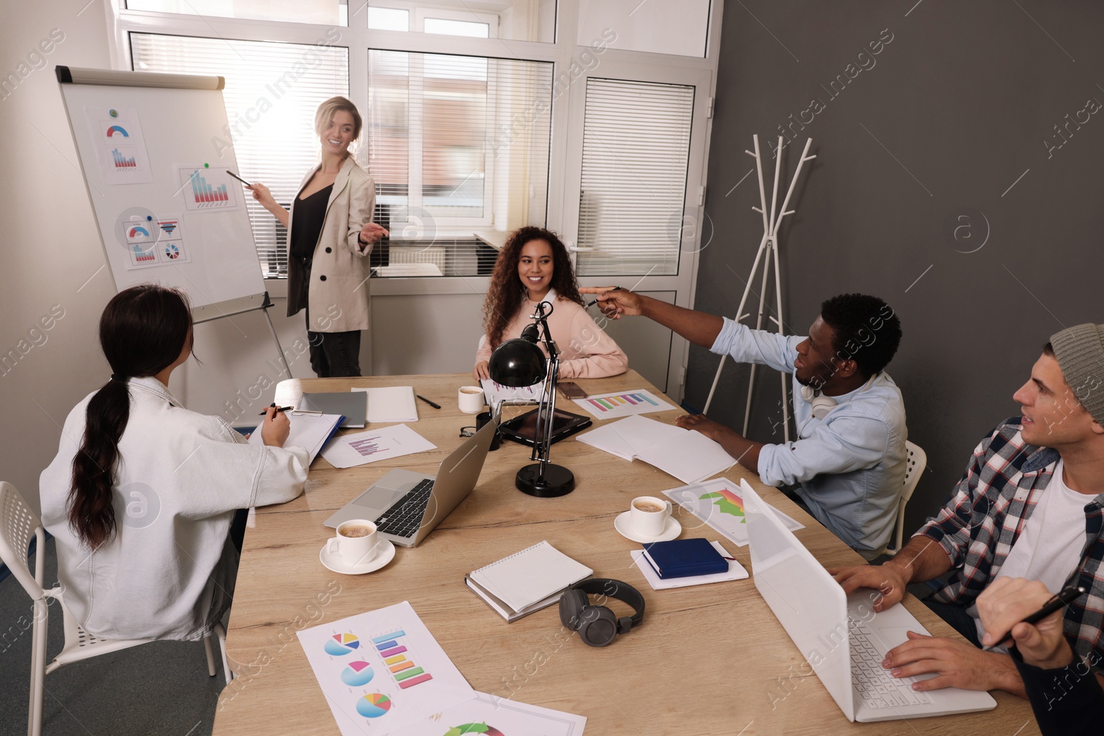 Photo of Team of employees working together in office. Startup project