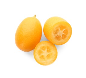 Photo of Cut and whole fresh kumquats on white background, top view