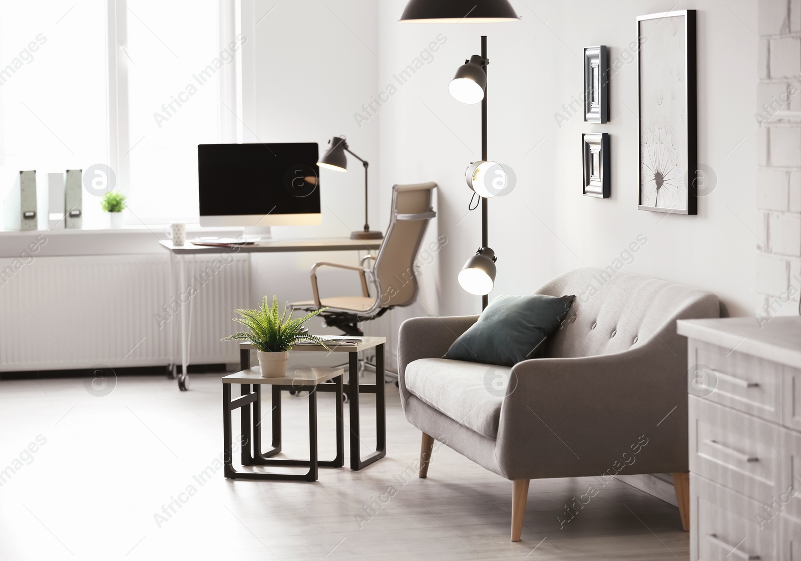 Photo of Room interior with modern lamps and comfortable sofa