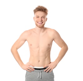 Portrait of young man with slim body on white background