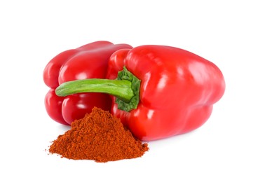 Fresh bell peppers and paprika powder on white background