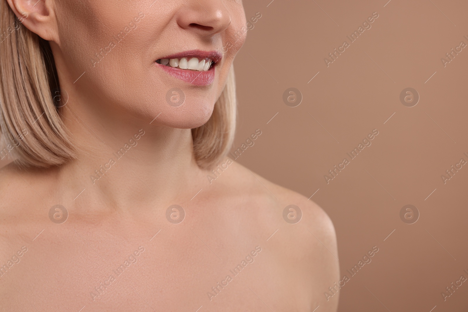 Photo of Woman with healthy skin on beige background, closeup