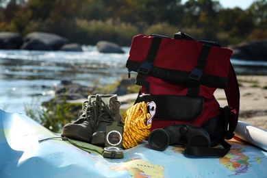 Photo of Set of camping equipment with map outdoors