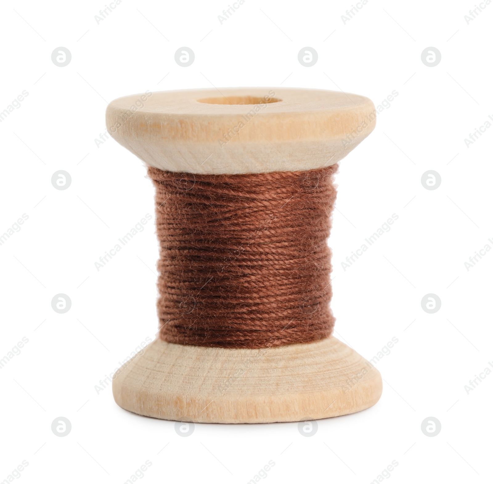 Photo of Wooden spool of brown sewing thread isolated on white