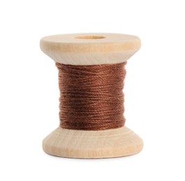Photo of Wooden spool of brown sewing thread isolated on white