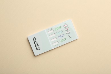 Photo of Multi-drug screen test on beige background, top view