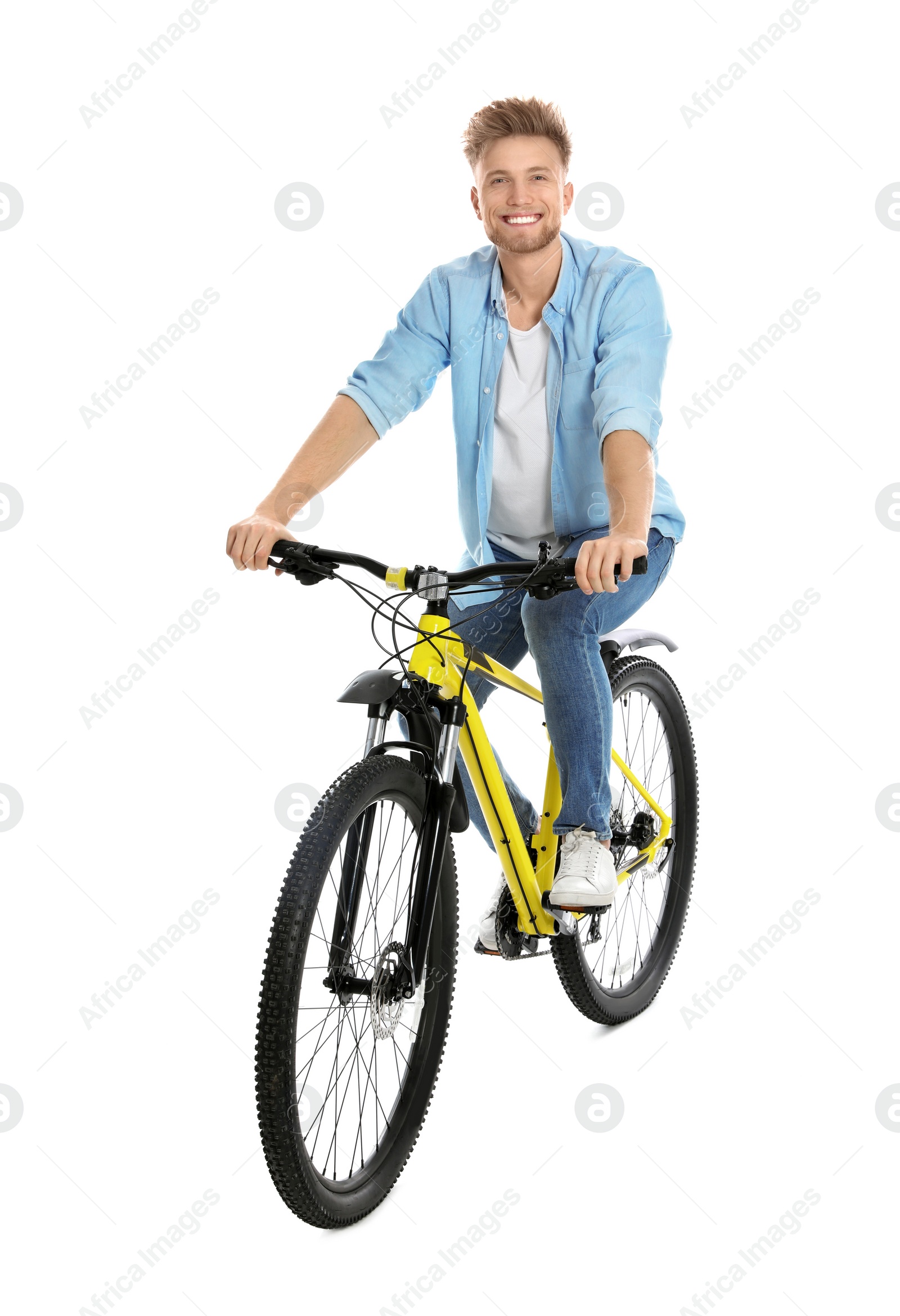 Photo of Handsome young man riding bicycle on white background