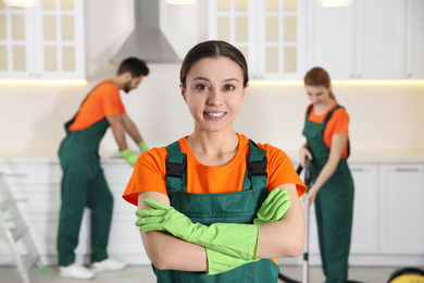 Photo of Professional janitor in uniform indoors. Cleaning service