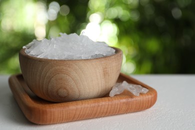 Photo of Menthol crystals on white table against blurred background