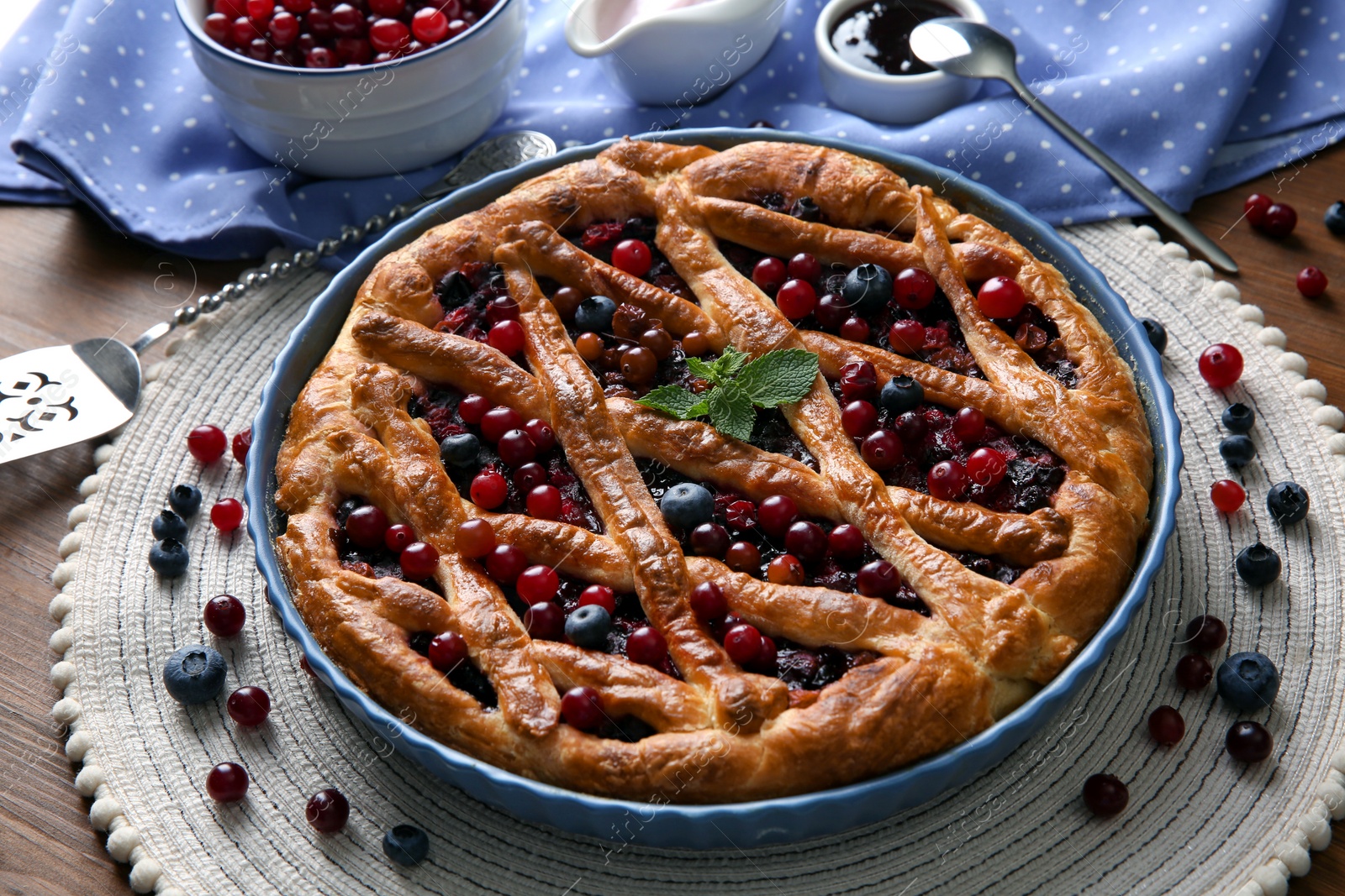 Photo of Delicious currant pie with fresh berries on wooden table