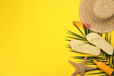 Photo of Flat lay composition with beach objects on yellow background, space for text