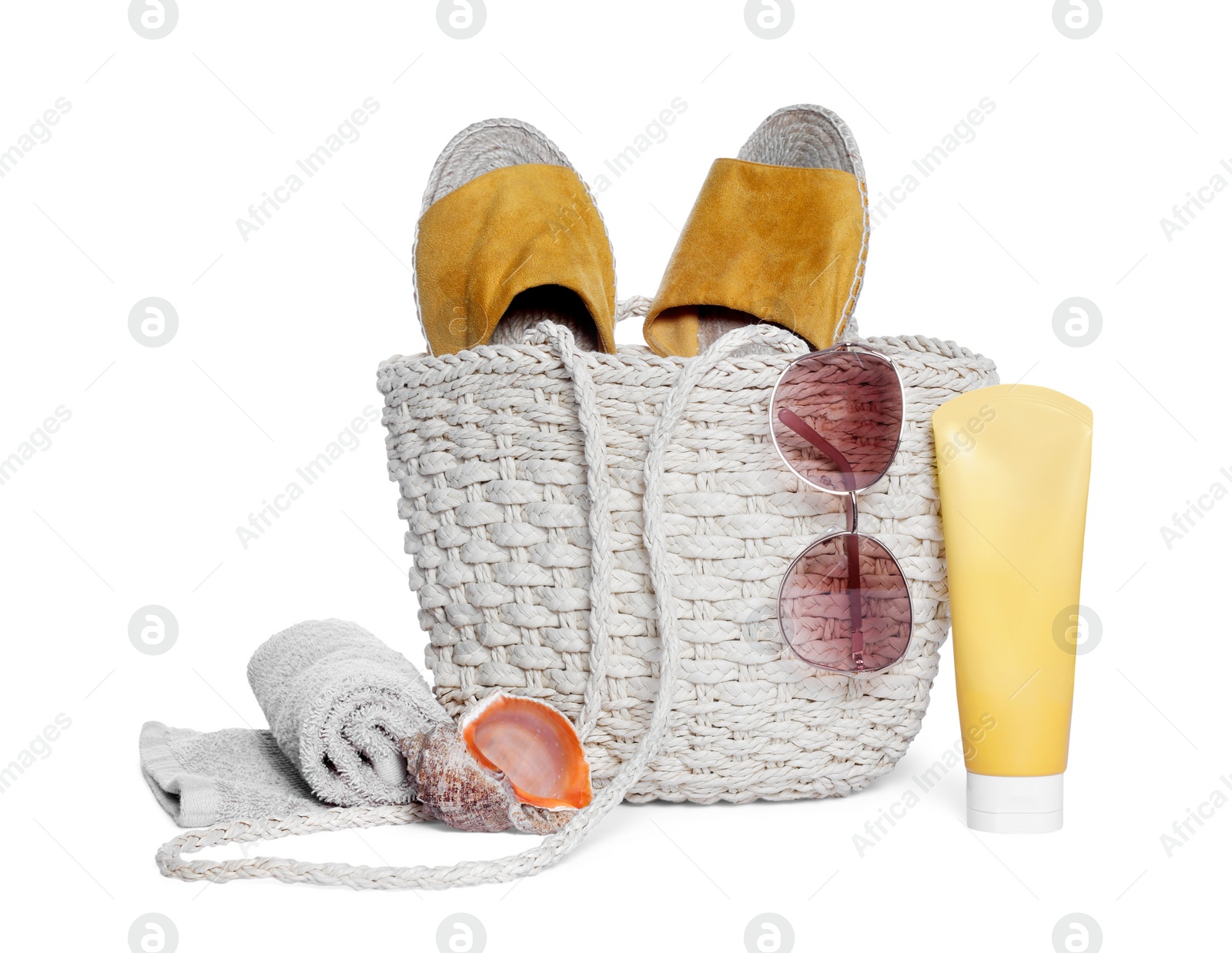 Photo of Stylish bag, sea shell and other beach accessories isolated on white