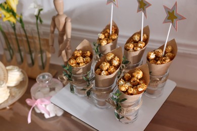 Delicious party treats on wooden table indoors