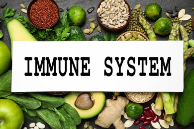 Image of Immune system boosting with proper nutrition. Different foods on black table, flat lay