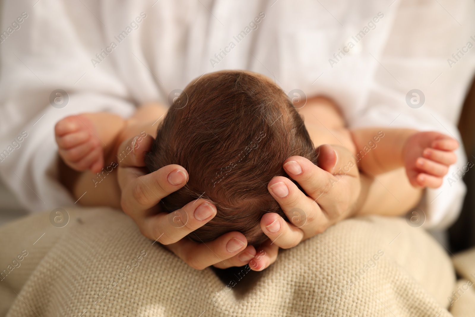 Photo of Mother holding her newborn baby, closeup view