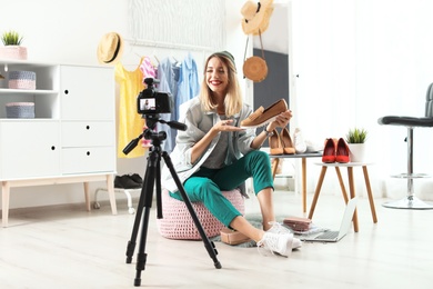 Fashion blogger recording video on camera at home