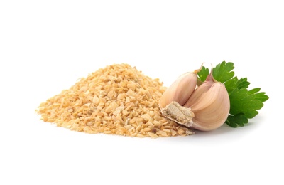 Pile of granulated dry garlic and parsley on white background