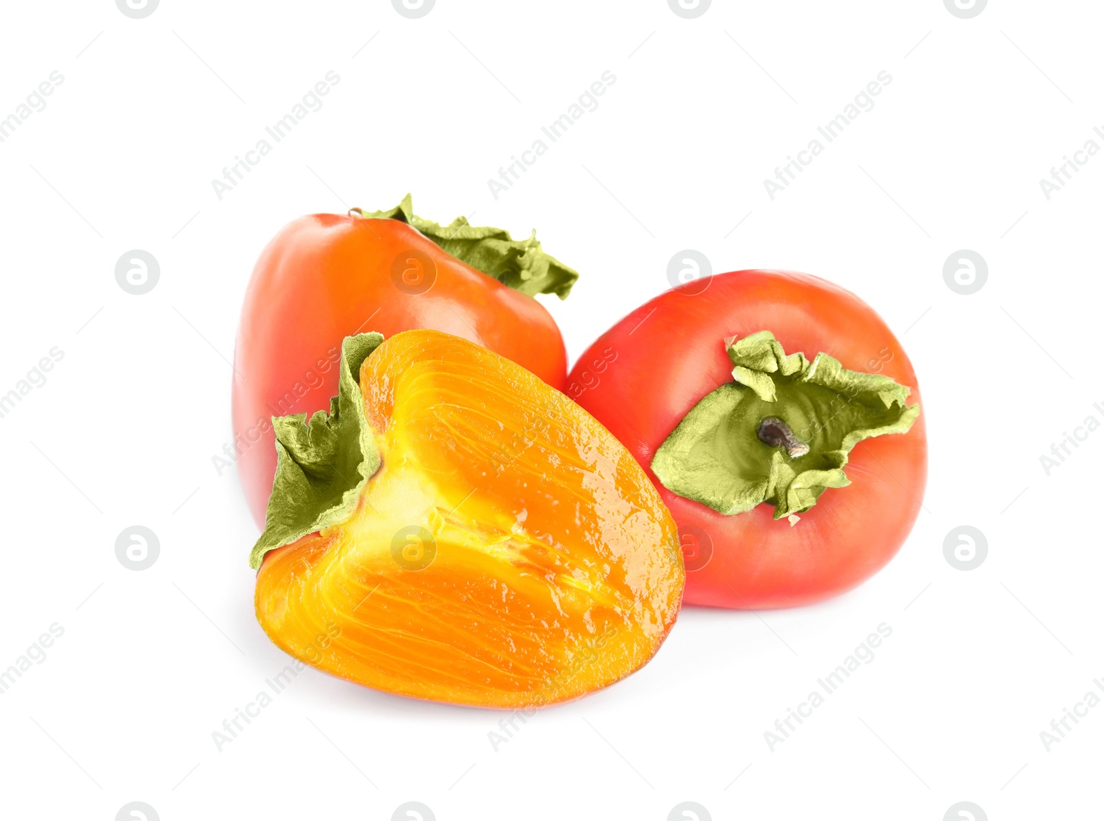 Photo of Delicious cut and whole fresh ripe persimmons isolated on white