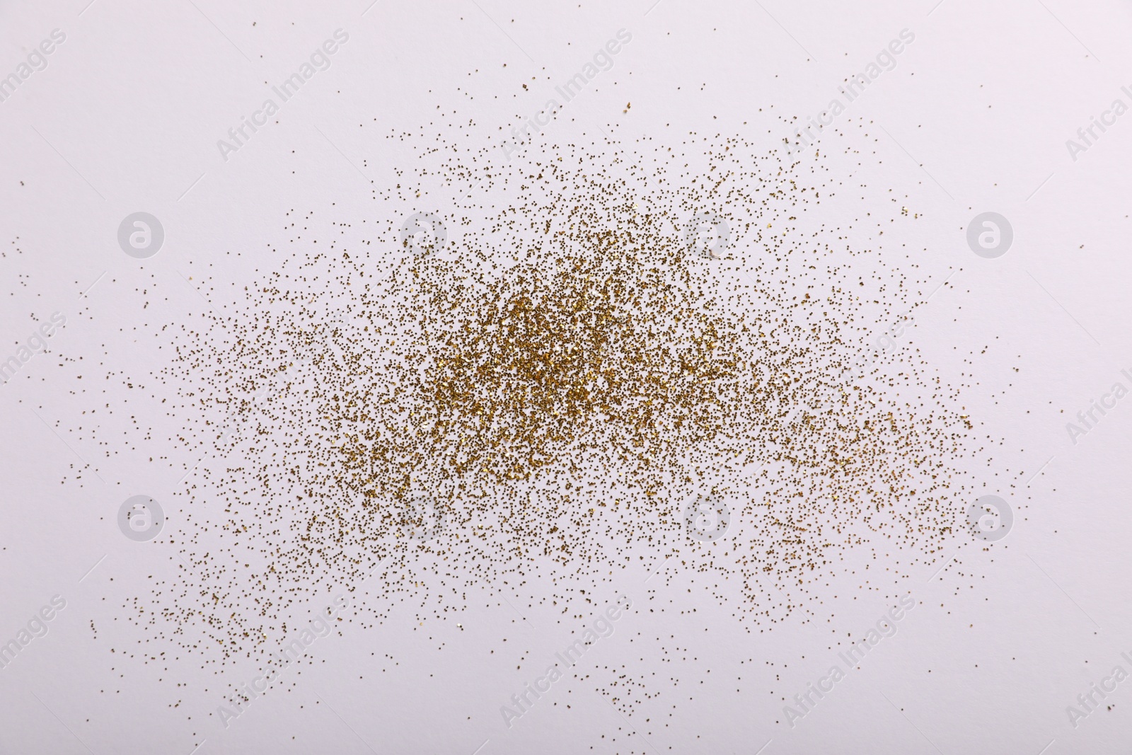 Photo of Shiny golden glitter on white background, top view