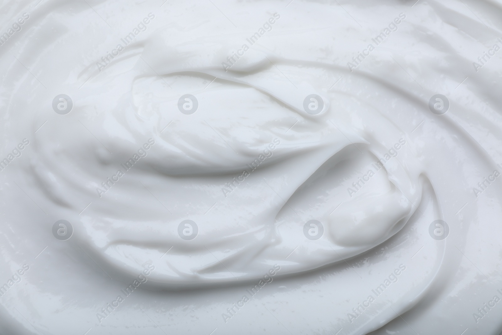 Photo of Closeup view of white body cream as background