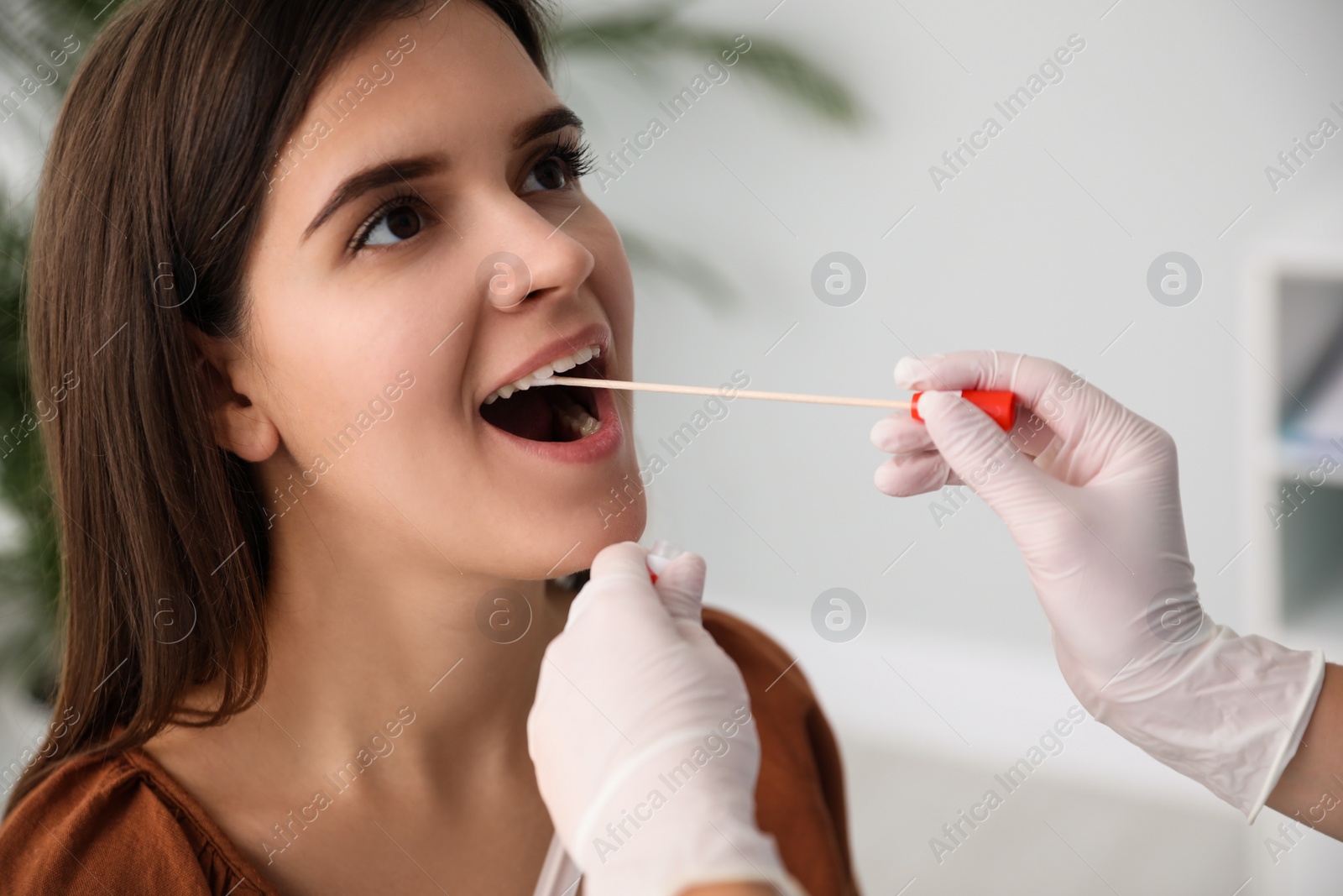 Photo of Doctor taking sample for DNA test from woman in clinic