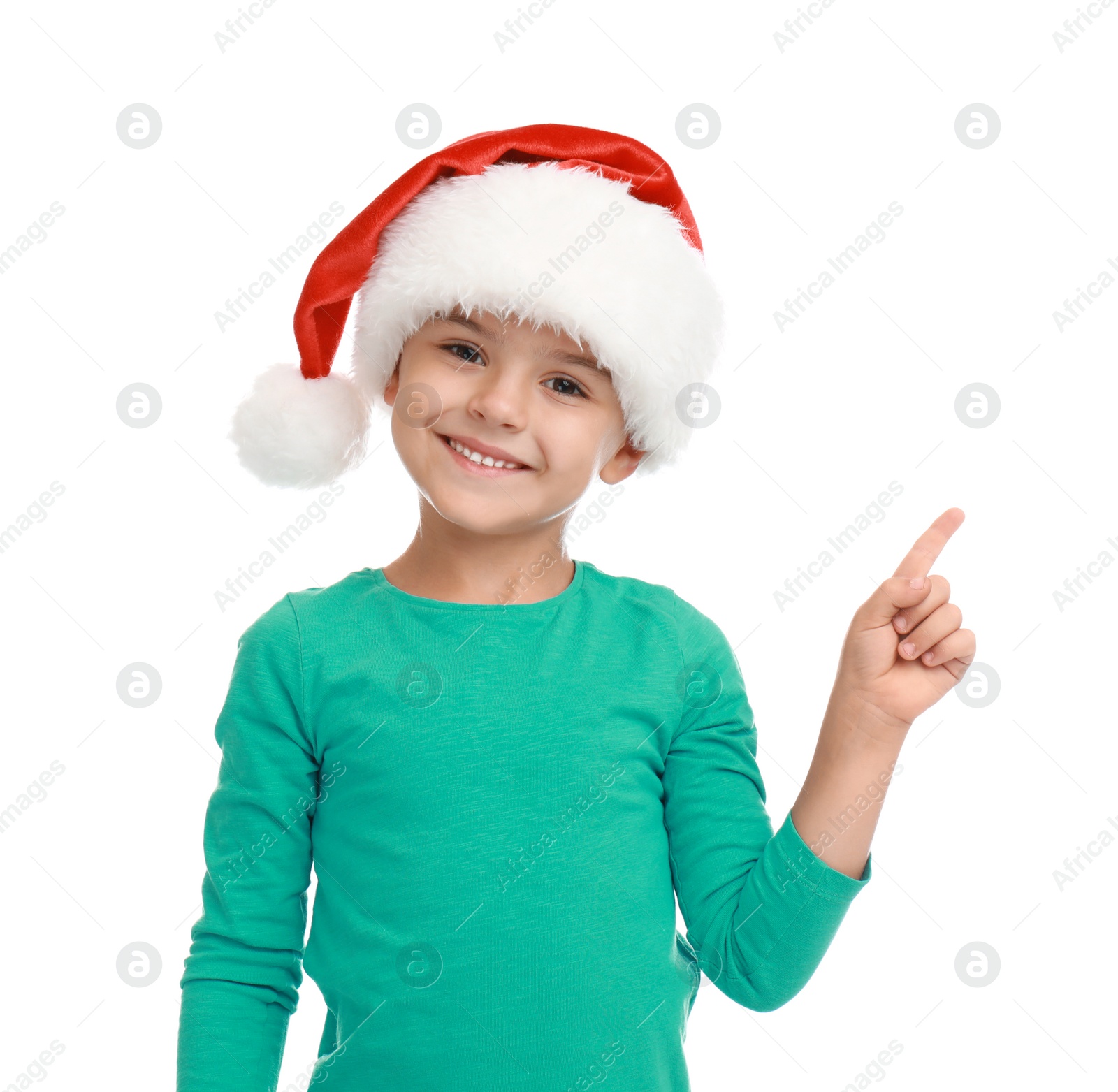 Photo of Cute little child wearing Santa hat on white background. Christmas holiday