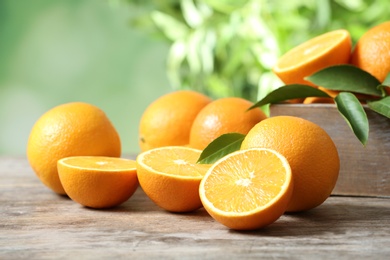 Ripe oranges on table against blurred background