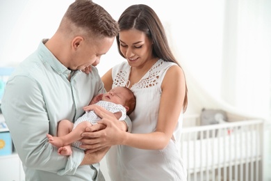 Happy couple with their newborn baby at home