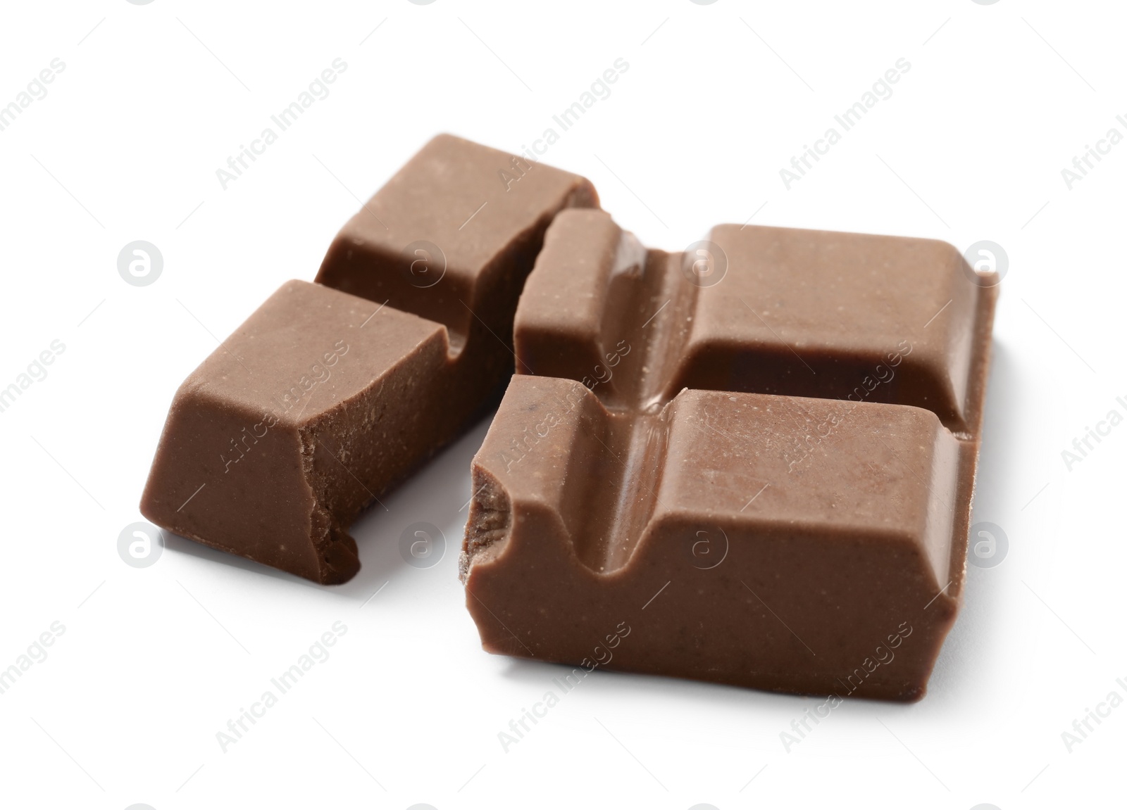 Photo of Pieces of delicious milk chocolate isolated on white