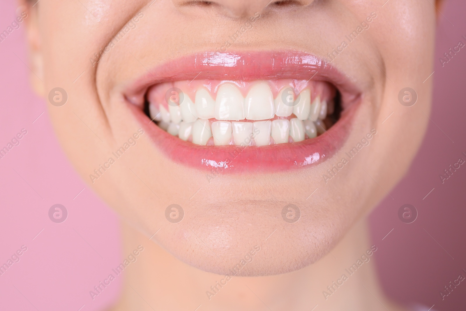 Photo of Young woman with healthy teeth and beautiful smile on color background, closeup