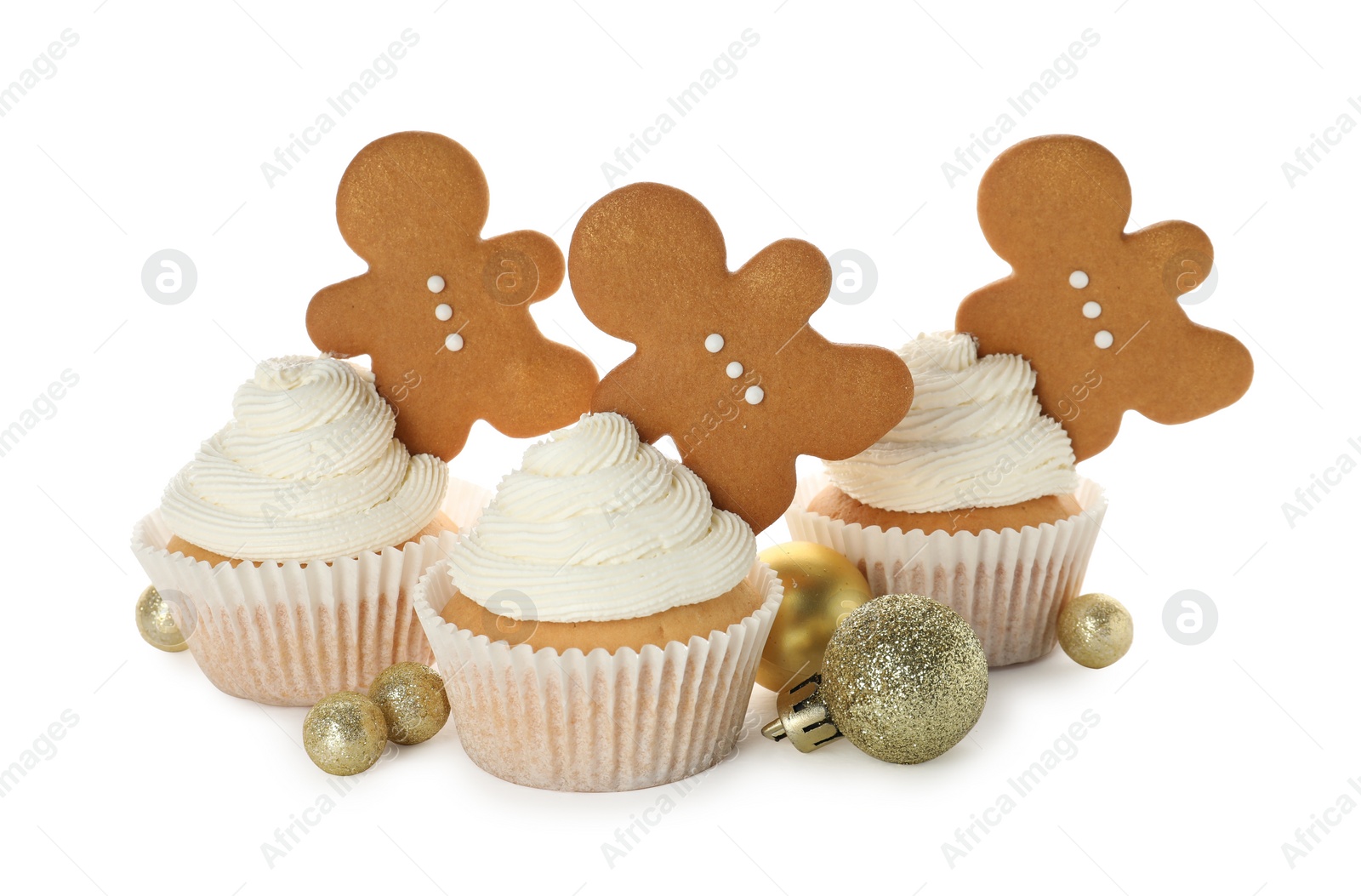 Photo of Tasty cupcakes with gingerbread men and Christmas baubles on white background