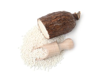 Pile of tapioca pearls, scoop and cassava root isolated on white, top view