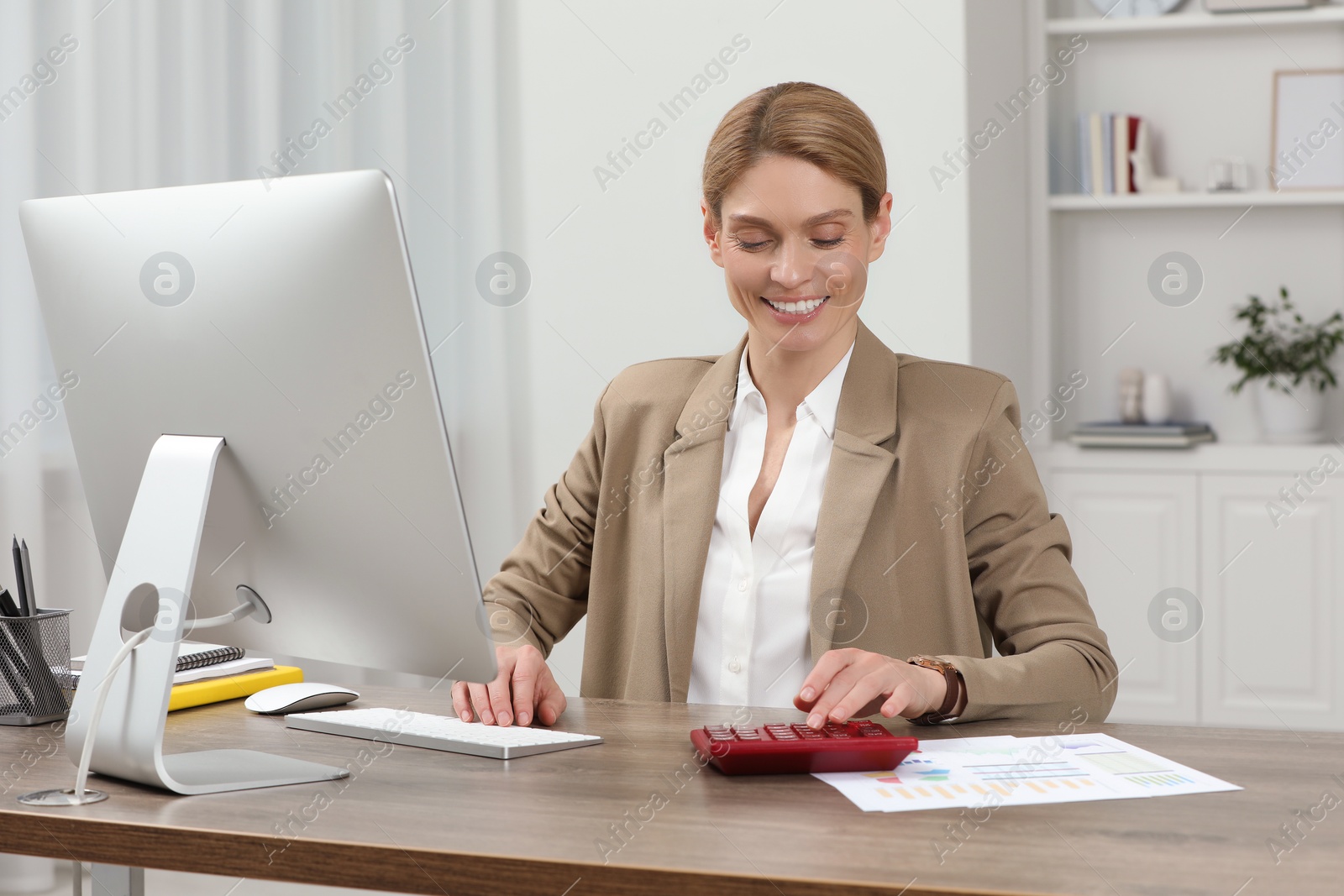 Photo of Professional accountant working at wooden desk in office