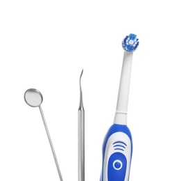 Photo of Professional dental tools and electric toothbrush isolated on white