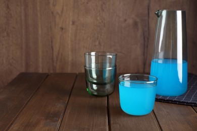 Photo of Delicious blue drink on wooden table. Space for text