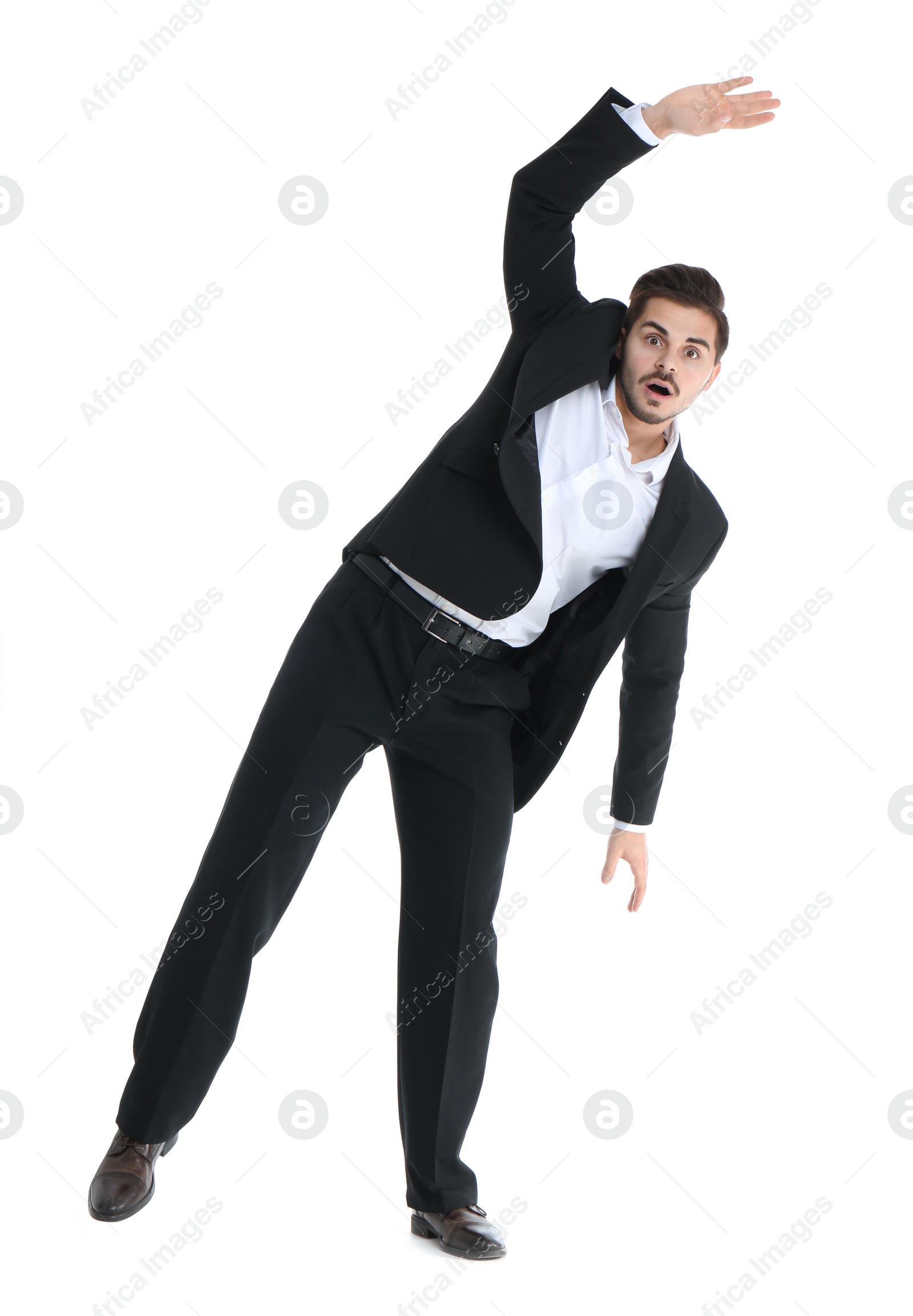 Photo of Young businessman attracted to magnet on white background