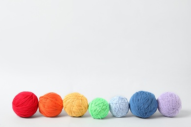 Photo of Soft colorful woolen yarns on white background