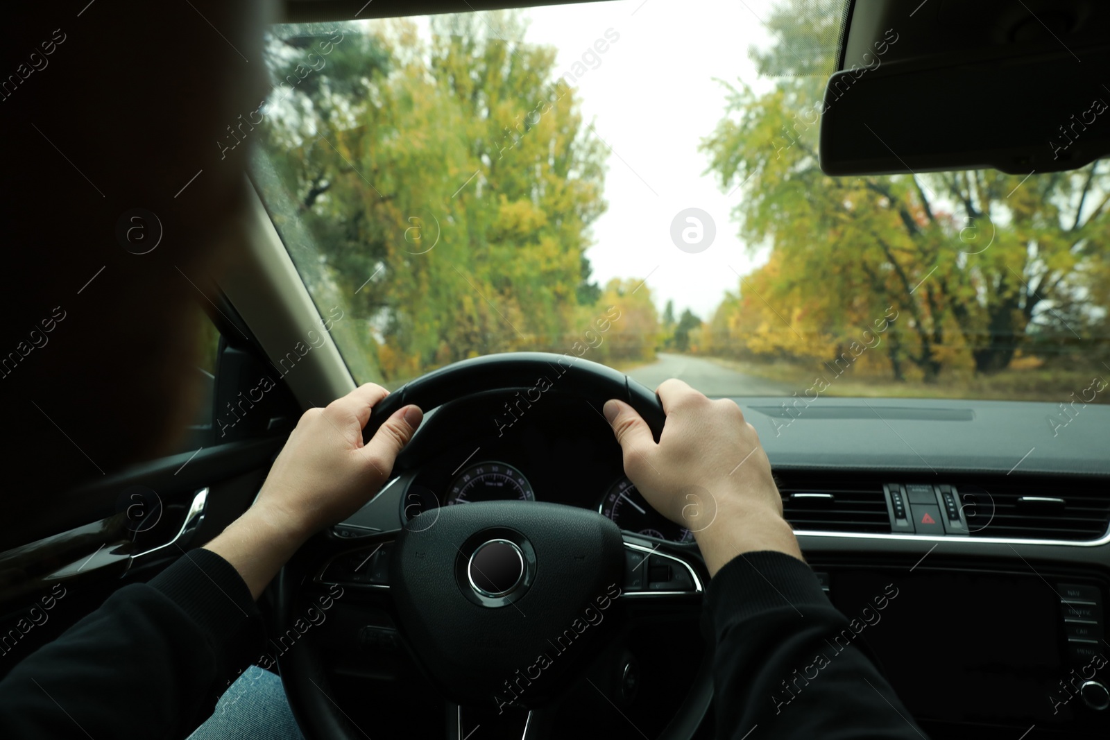 Photo of Man driving his car, closeup. Traffic rules