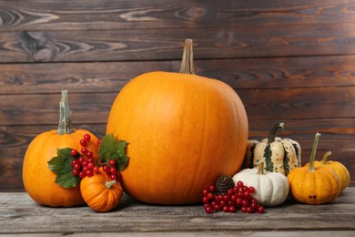 Happy Thanksgiving day. Composition with pumpkins and berries on wooden table