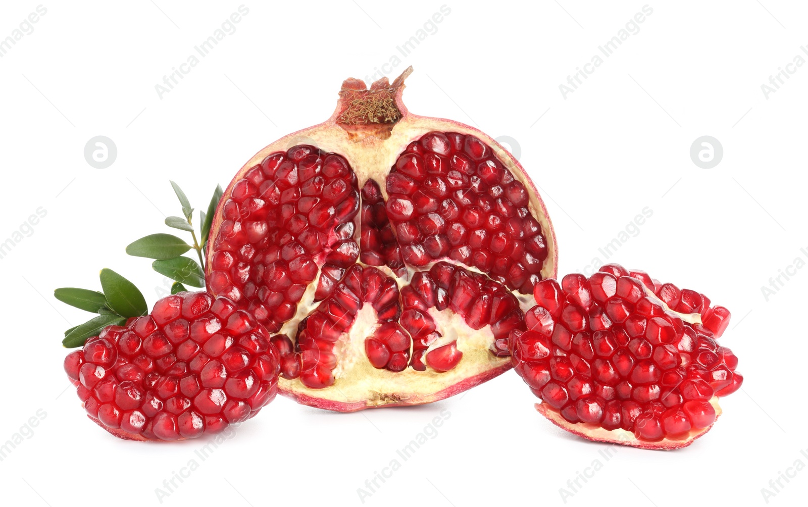 Photo of Fresh cut pomegranate and branches isolated on white